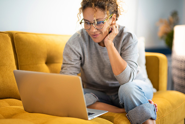 Woman smiling at laptop